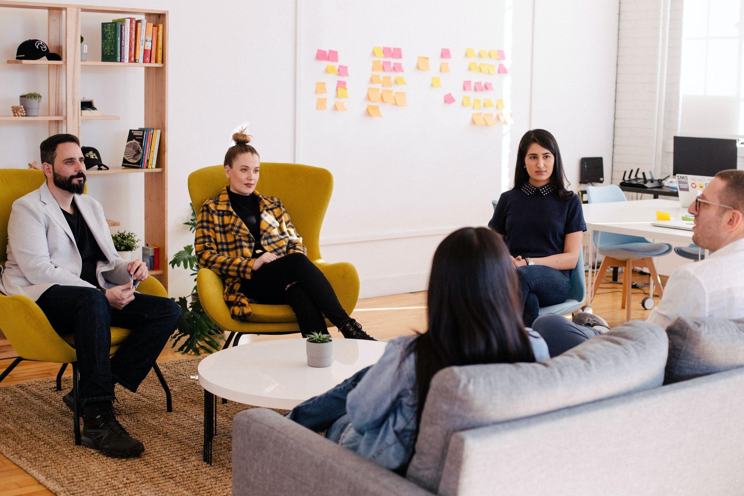 People sat around a coffee table in an office